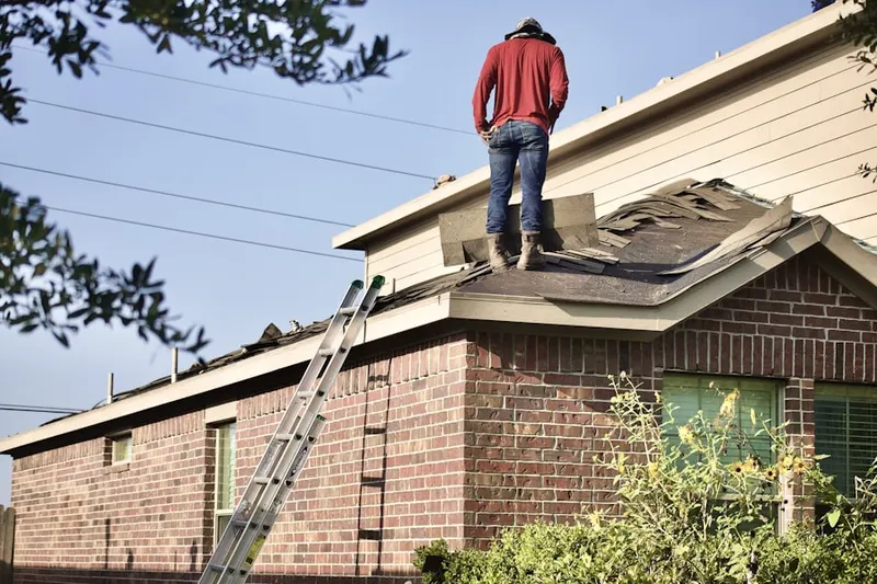 Professional roofer working on a residential roof in Ford Oaks